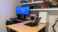 FlexiSpot E7L with a monitor, keyboard, mouse, XBox controller, desktop and a laptop.