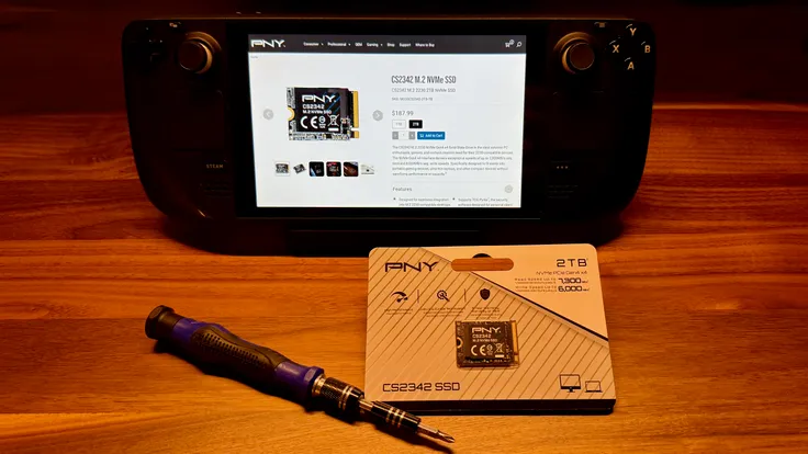 The PNY CS2342 NVMe next to a screwdriver and SteamDeck with the product's webpage on the SteamDeck.