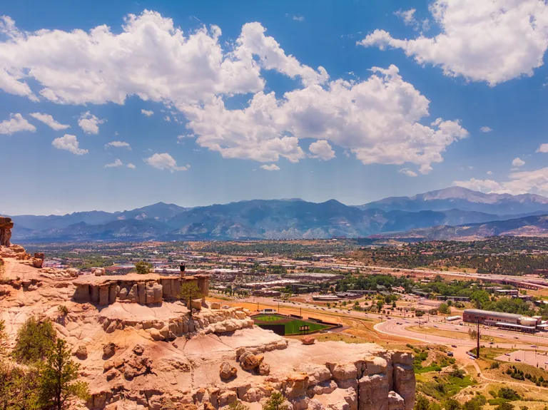 Michael near the top of Pulpit Rock with Pikes Peak in the background